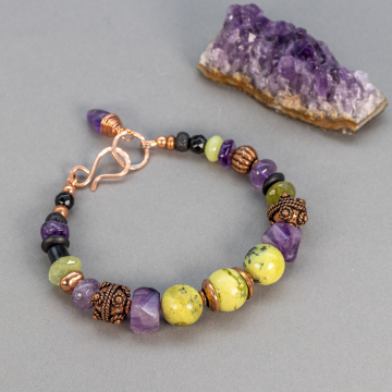 Beaded Gemstone Bracelet in Black, Purple, and Yellow Green on Gray Background