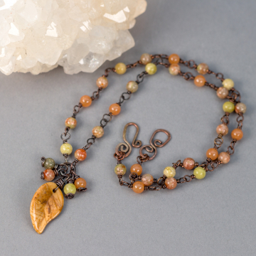 Orange Yellow and Olive Color Gemstone Necklace Shown on a Gray Background