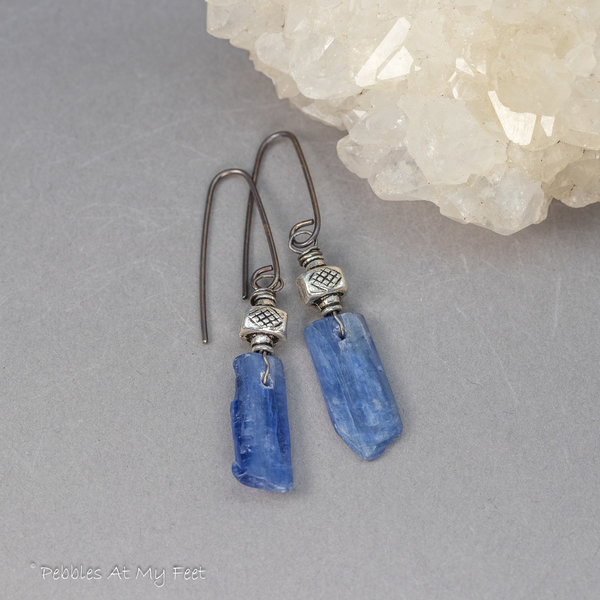 Handmade earrings with blue kyanite stone shards and cross-hatched textured silver beads.